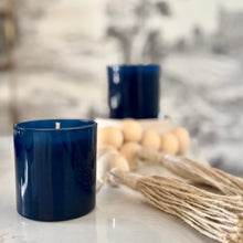 Load image into Gallery viewer, Two navy blue candles on a white surface with decorative elements.