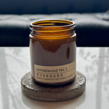 Load image into Gallery viewer, Sandalwood No.1 candle by ZCandles on a stone coaster with a blurred background

