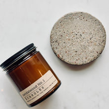 Load image into Gallery viewer, Candle jar labeled 'Sandalwood No. 1' next to a textured stone coaster on a marble surface
