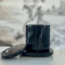 Load image into Gallery viewer, Black marble-patterned container with lid on a light surface, blurred floral background
