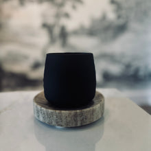 Load image into Gallery viewer, Black ceramic cup on a gray stone coaster with a blurred natural background
