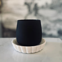 Load image into Gallery viewer, Black ceramic cup on a white ceramic coaster with a blurred background

