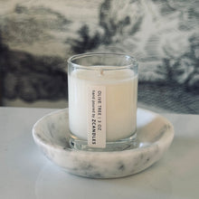 Load image into Gallery viewer, Candle in a glass holder on a marble coaster with a blurred background
