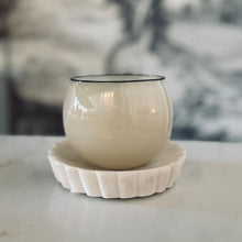 Load image into Gallery viewer, White textured vase on a matching white coaster with a blurred abstract background
