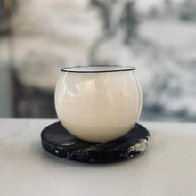 Load image into Gallery viewer, White glass candle holder on a black marble coaster with a blurred background
